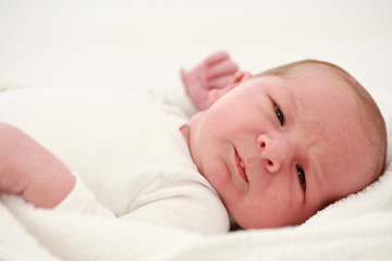 Lying baby on white background