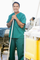 An Orderly Mopping The Floor In A Hospital Ward