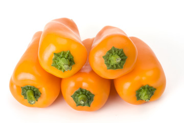 five orange bell peppers on white background