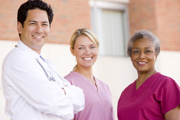 Fototapeta premium Doctor And Nurses Standing Outside A Hospital
