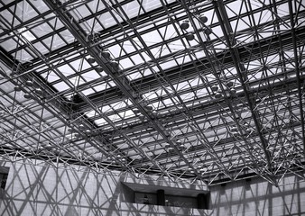 A glass covered ceiling with a system of beams..