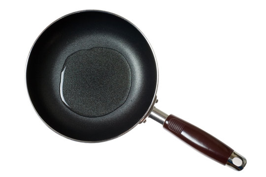 Frying pan with cooking oil isolated on white background.