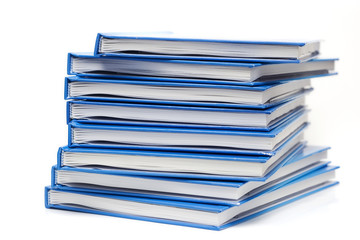 stack of books with blue covers isolated on white