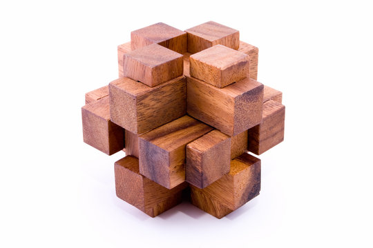 Assembled 24 piece burr puzzle in wood on white background