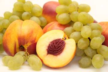 Bright, ripe fruit - grapes and nectarines. Object over white