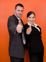 woman and man in team standing on orange background