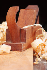 Old wooden plane and shaving