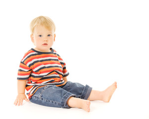 Beautiful child sitiing. Isolated on white background