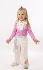 Portrait of the girl in a pink jacket and white trousers