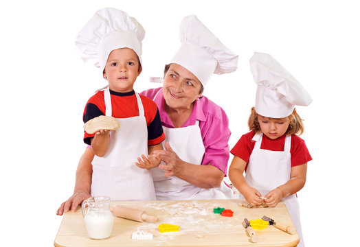 Kids with grandmother preparing cookies - isolated