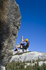 Rock climber rappelling.