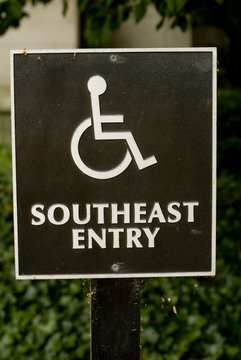 Handicap symbol on black entry sign