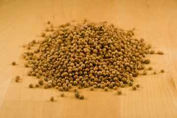 Coriander seeds on wood