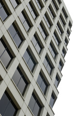 View upward of a  tall cream building with many glass windows