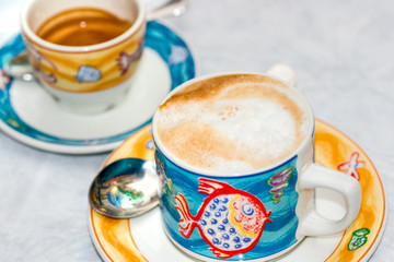 Hot Cappuccino cup  with Coffe cup in the background