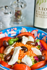 Mix salad with mozzarella and olives.
