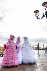 Three elegant masks in Venice, Italy.