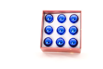 Box of blue christmas balls on the white background
