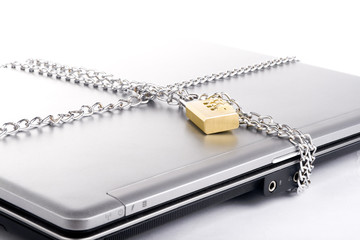 Laptop with chains and combination padlock isolated on white