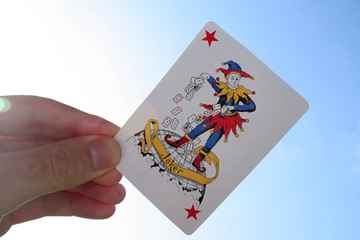Joker with hand and sky