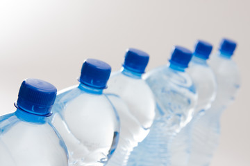 bottles of clear water with blue cap