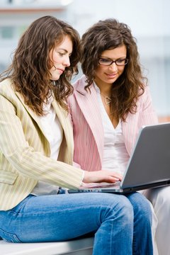 Young creative businesswomen team working on laptop