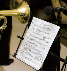 Naklejka premium A music score and a musician whit trumpet