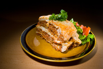 Beef lasagne with salad. Melting mozzarella and ricotta cheeses