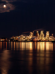 Petrochemical plant at night with a full moon