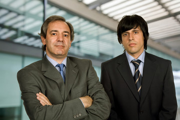 Fototapeta premium two young business men portrait, focus on the right man