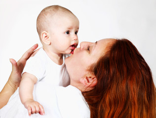 A happy mother playing with a baby