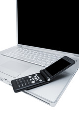 Mobile phone on the keyboard of a computer