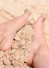 foot in gold dust on the beach