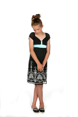 shy girl in black dress with legs and hands crossed