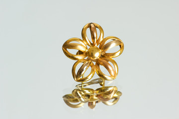 Flower shaped ring on the reflective background