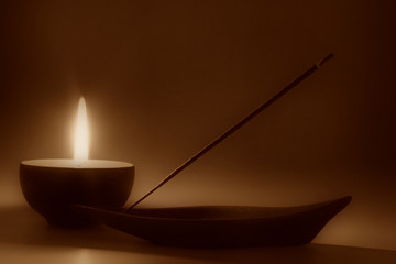 Still life with candle and incense stick, sepia toned