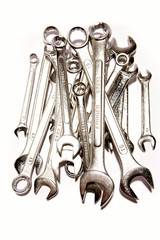 Assorted spanners over white background