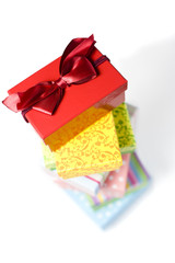 stack of colorful gift boxes, box with lanyard on top in focus