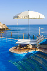 Beautiful blue swimming pool on the seaside