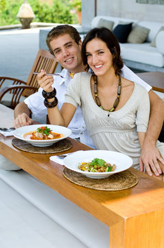 Young couple on vacation eating lunch at a outdoor restaurant