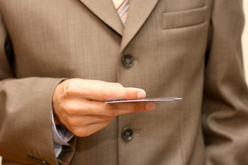 man in coat with plastic card