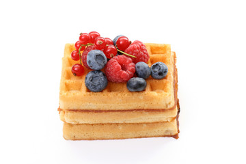 delicious waffles with various fruits isolated on white