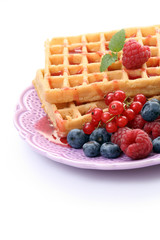 delicious waffles with various fruits isolated on white