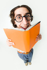 Portrait of smiling male in glasses reading interesting book