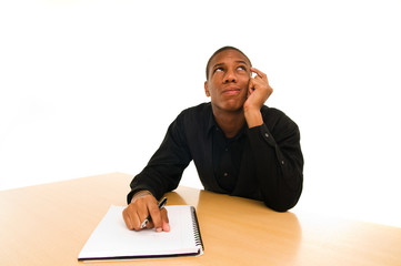 man sits at table with confused look on face