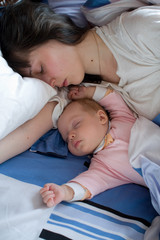 Baby with mom in the bed