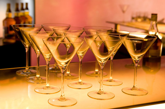 Empty martini glasses on bar counter