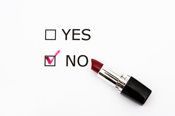 Paper with boxes with the words yes and no with lipstick, voting