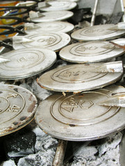 Iron mould for making Chinese Love Letters over charcoal