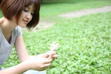 young woman picks flowers